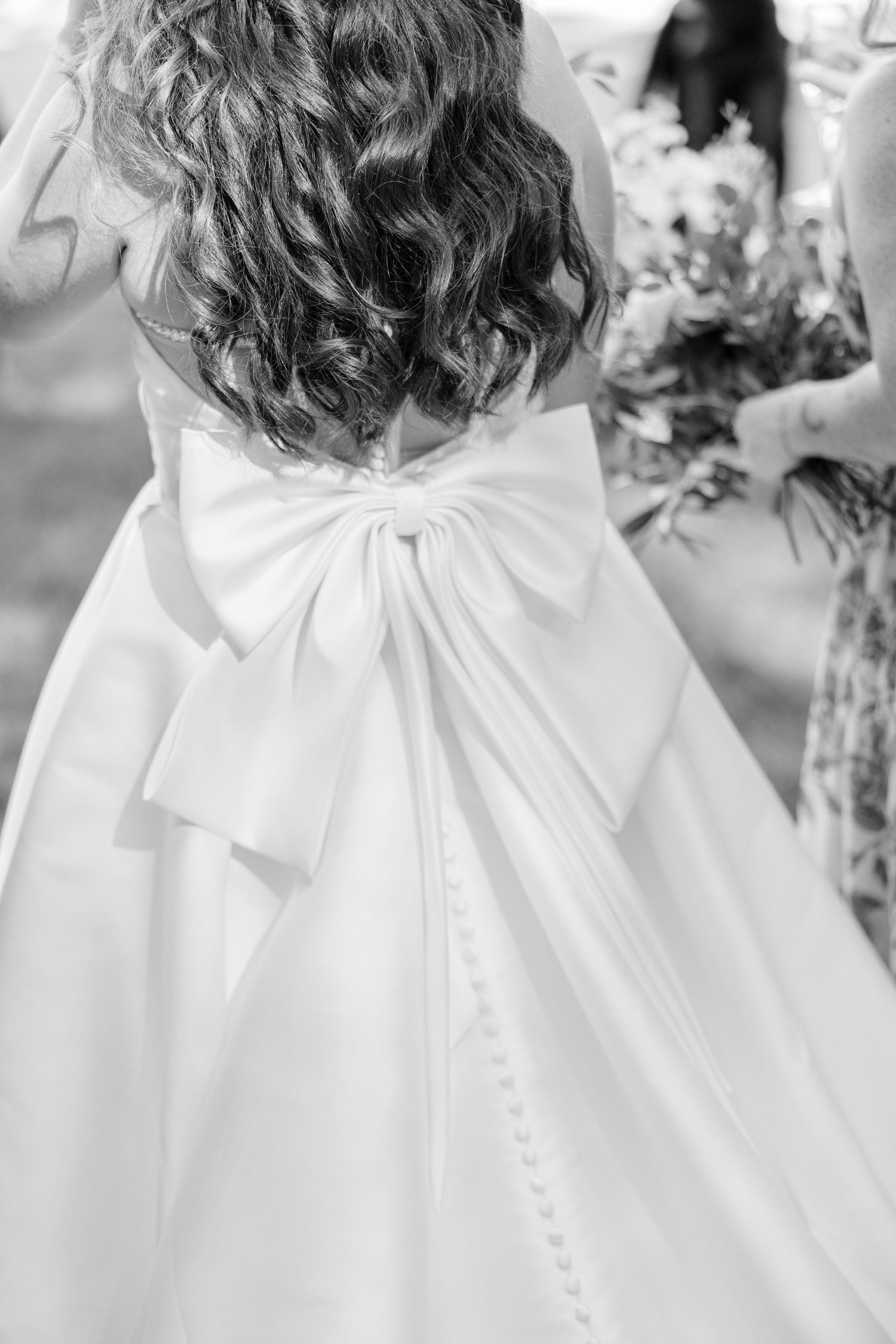 Back view collage showing delicate white bow details on white dresses with curled hair styling.