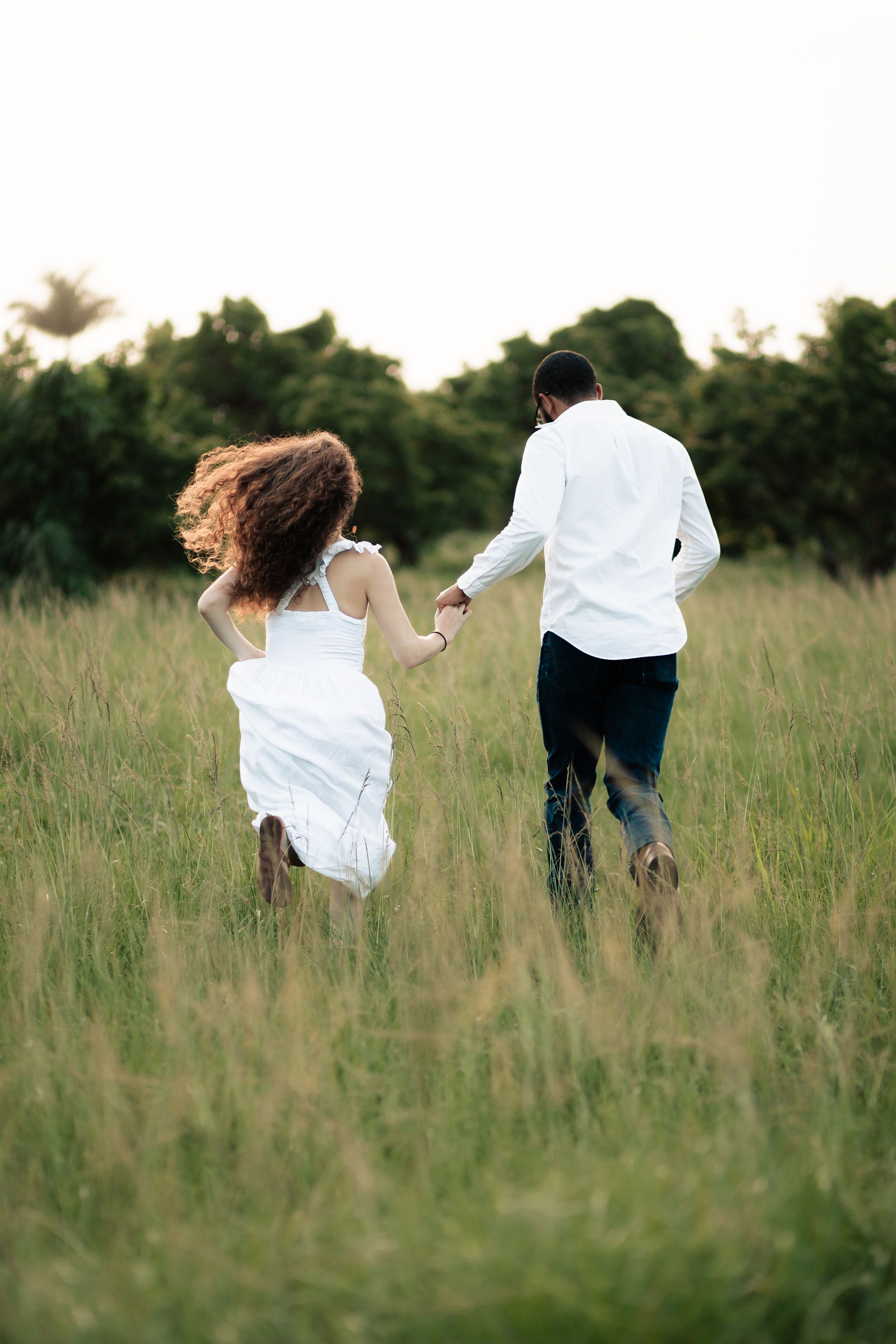 Romantic South Florida engagement shoot in golden field, Pinterest-worthy couples photography perfect for weddings by MannyPortraits.