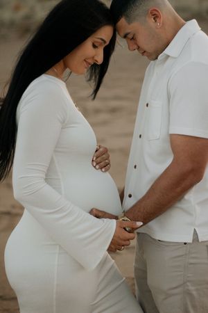 Admiring their baby bump Maternity session Pataua North