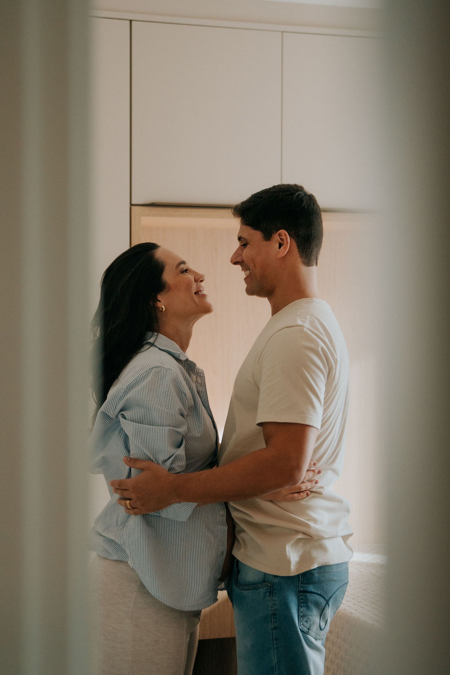 Romantic maternity photoshoot showing tender interactions in natural light.