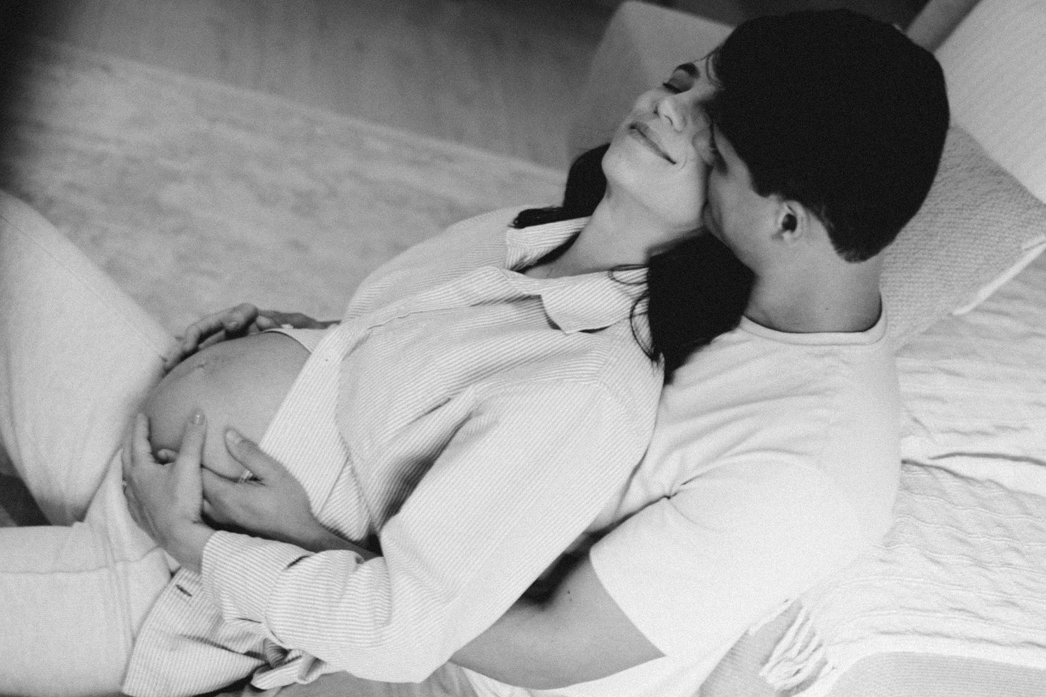 A series of black and white maternity photos showing gentle belly touches and relaxation.