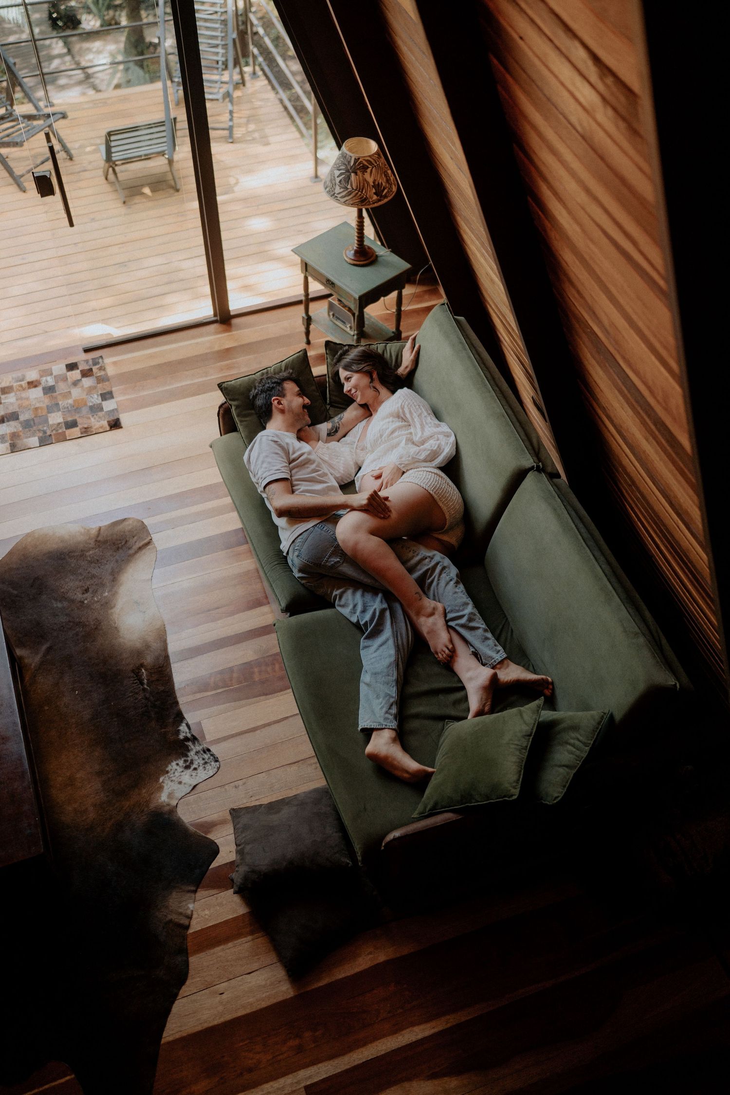 Overhead view of a maternity session in a rustic room with wooden floors.