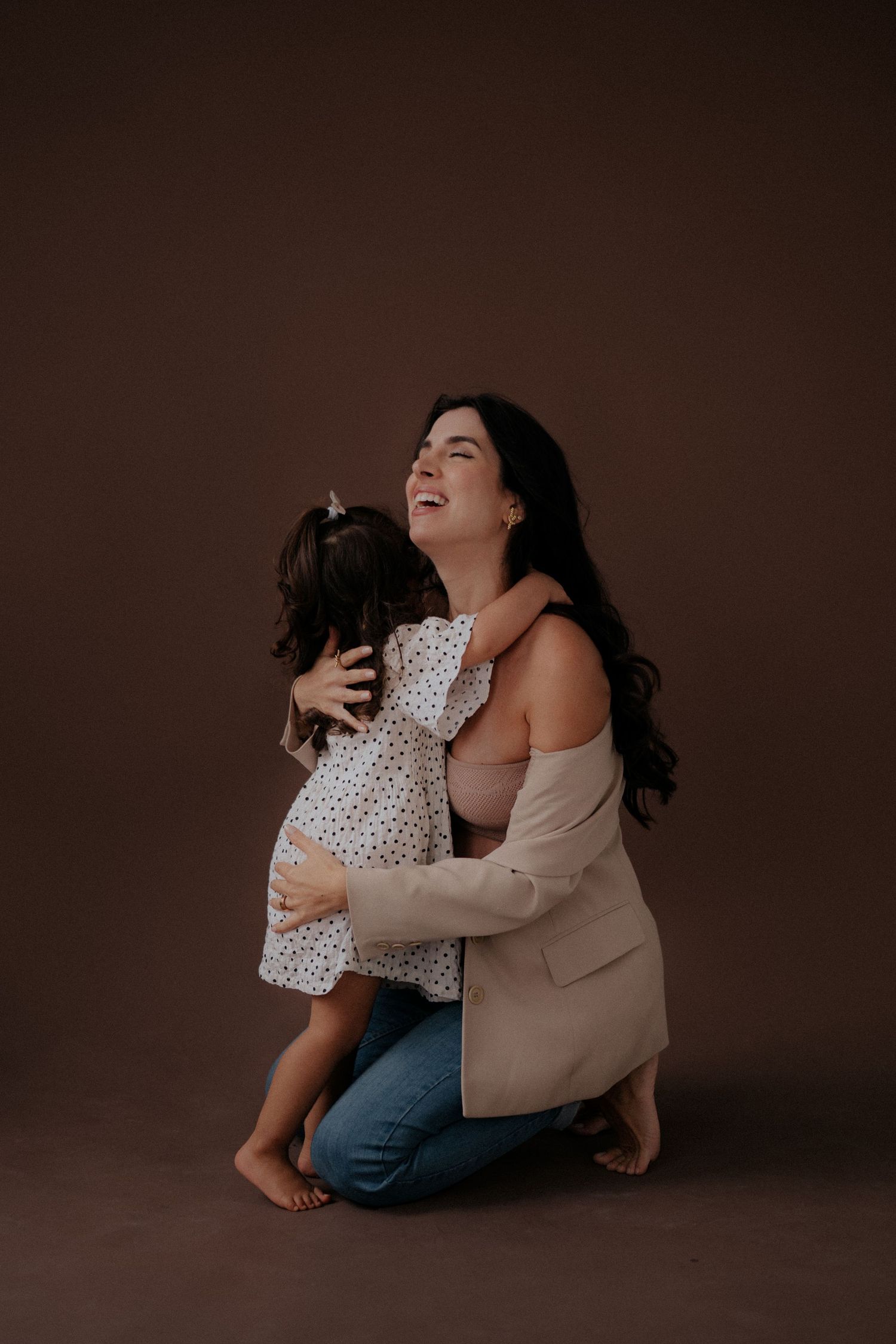 Heartwarming embrace between parent and child in matching neutral tones.
