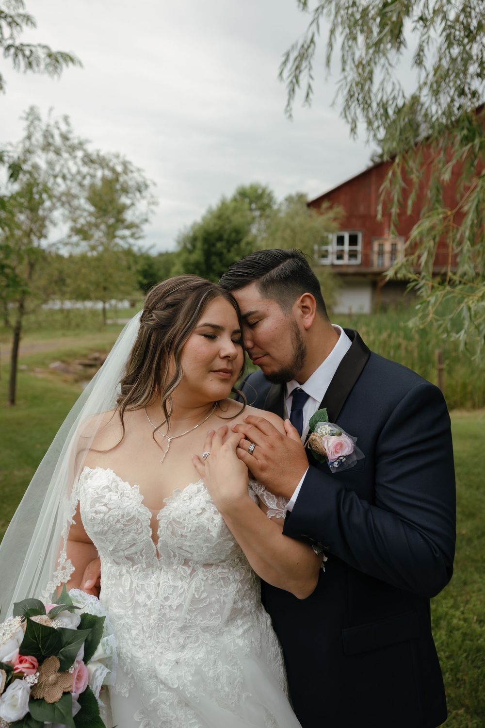 Intimate wedding portraits captured against a rustic farm setting with weeping willow trees.