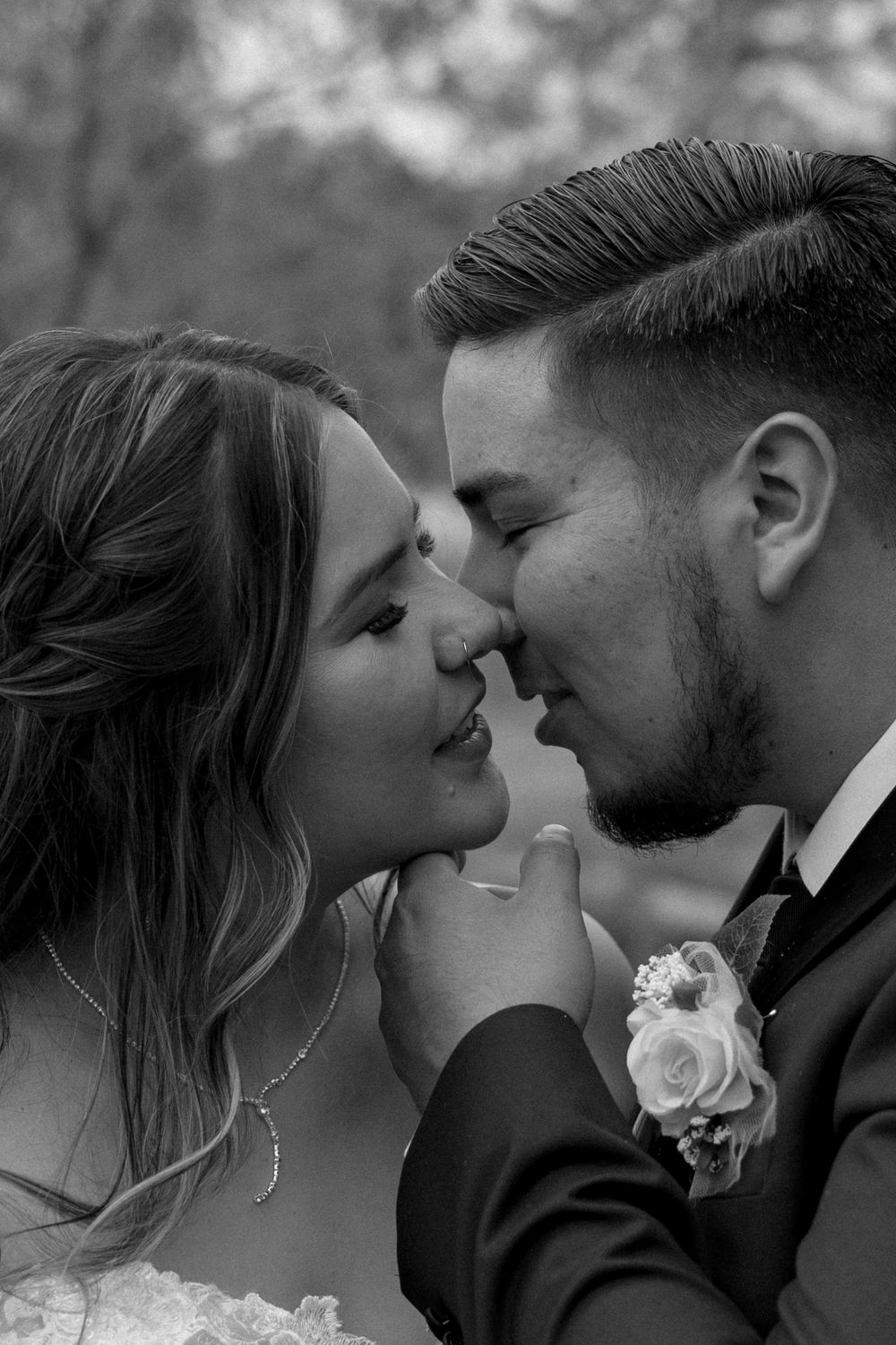 A series of intimate black and white wedding portraits showing tender moments between newlyweds.