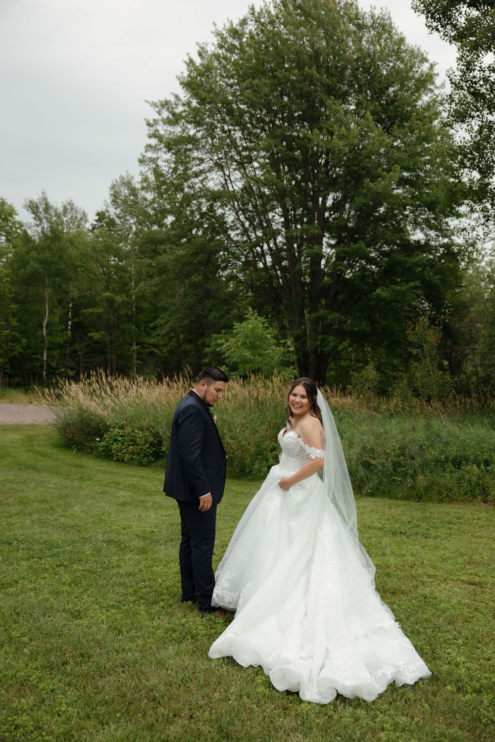 Romantic outdoor wedding photoshoot sequence showing tender moments between couple in grassy field with trees.