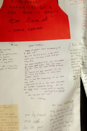 Handwritten letters printed onto grooms suit, wedding details candid photography