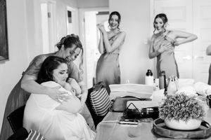 Black and white photos from bridal prep bride being hugged by one of her bridesmaids