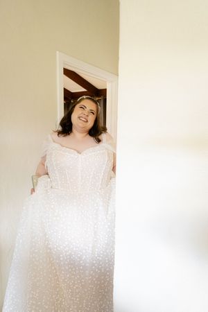 Sequence of photos showing joyful reactions while holding a white wedding dress.