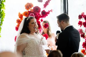 A romantic wedding scene shows tender moments between the couple dancing and embracing near colorful decorative flowers.