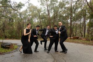 groomsmen laughing and posing in silly ways