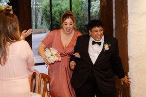 excited bridal party members make their entrance at the wedding reception candid photography