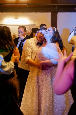 bride and groom holding each other in a slow dance wedding reception.