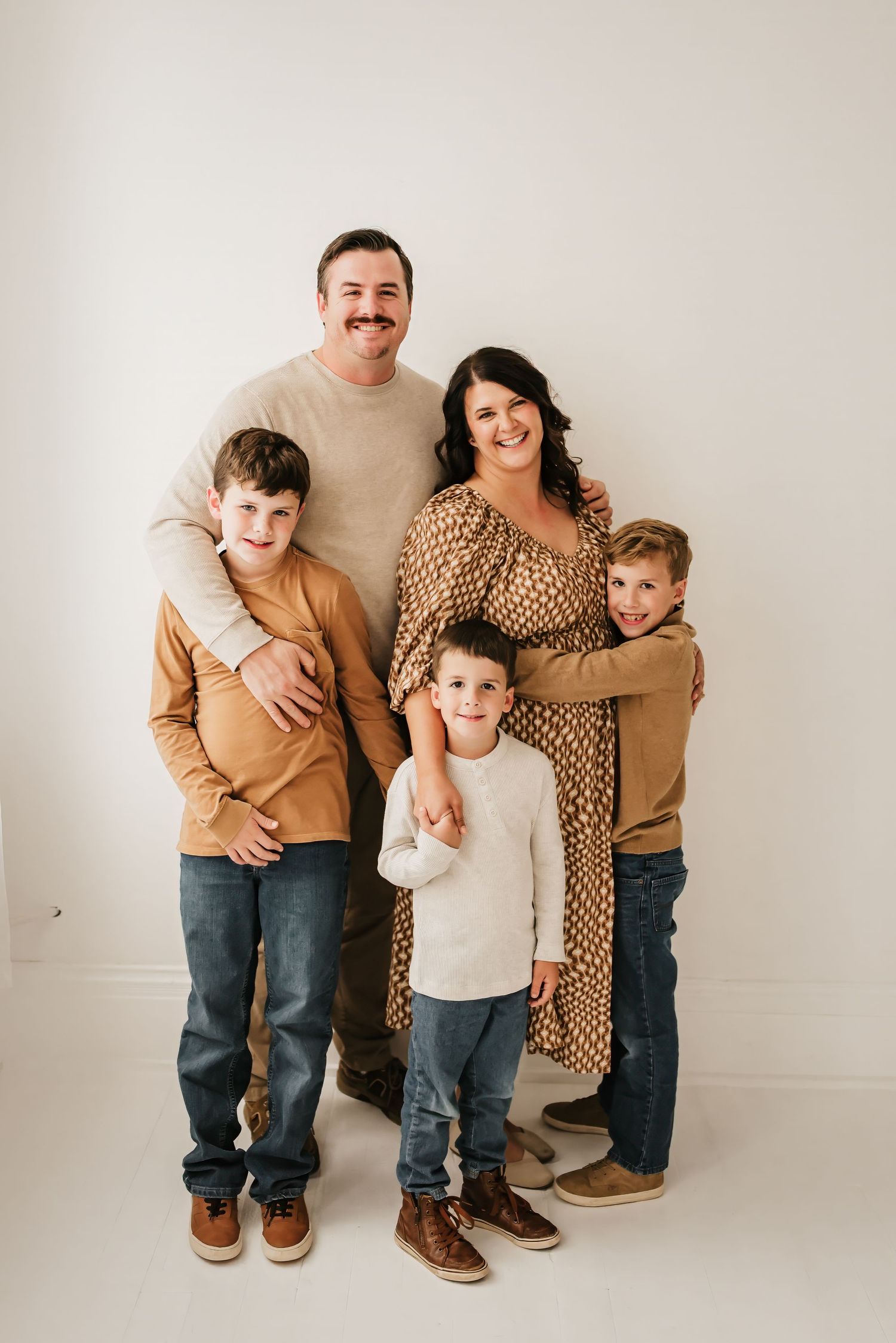 Family hugging and smiling for a candid mini session photo.