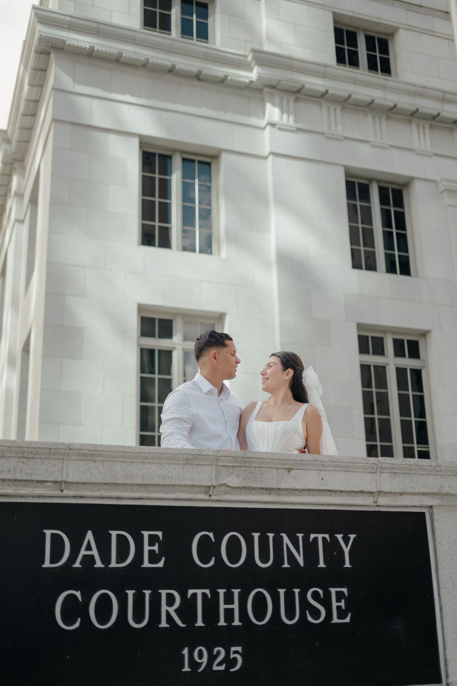 Couple shares romantic moment outside historic Dade County Courthouse built in 1925.