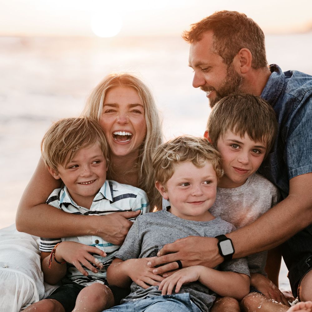 Family sharing joyful moments together while relaxing on a couch.