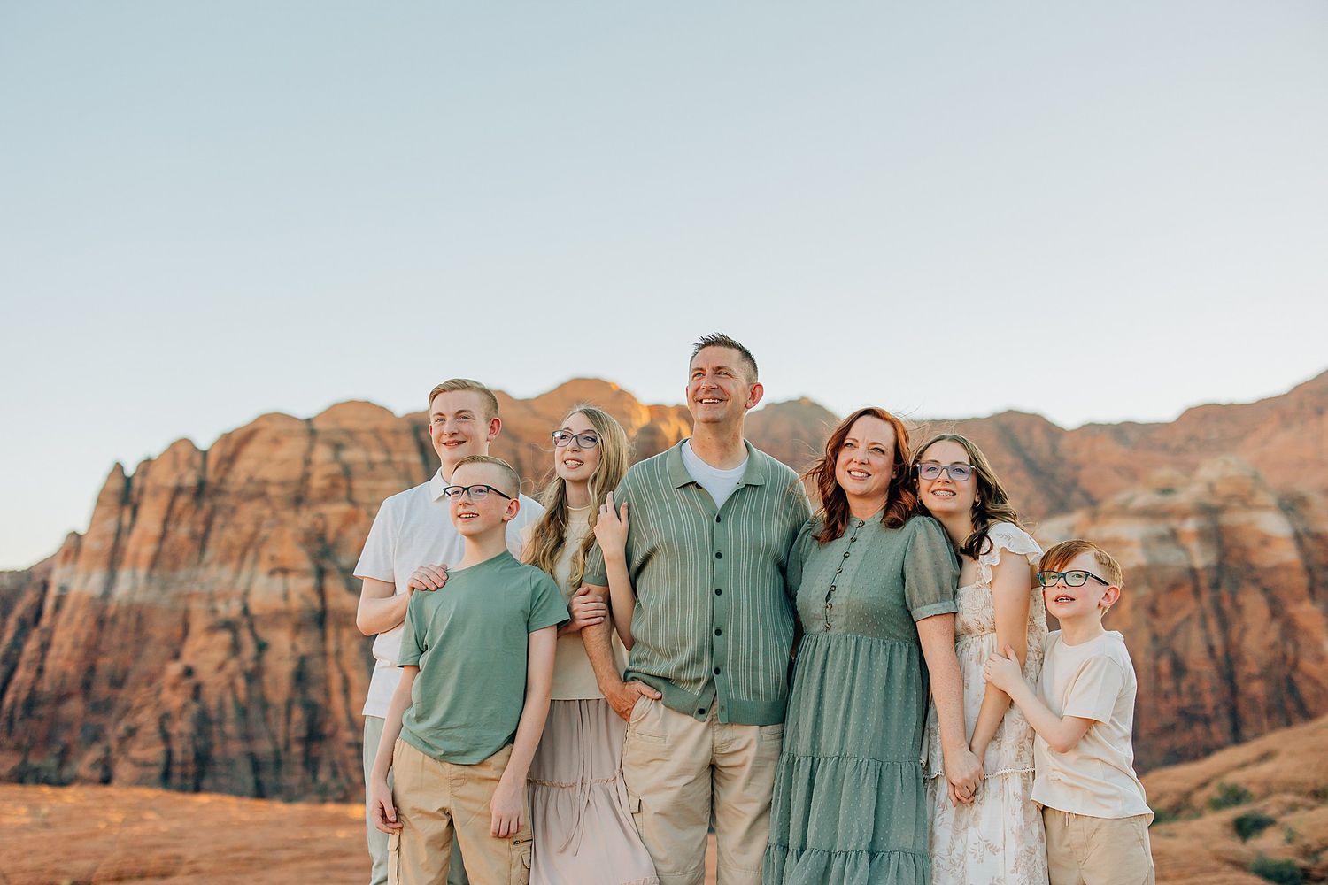 Group portrait session with desert mountains creating a dramatic backdrop.