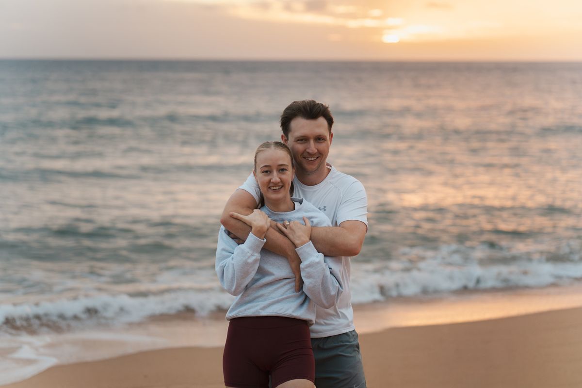 man hugs his girlfriend during a photoshoot for their secret proposal in the northern sydney Newport Beach photoshoot
