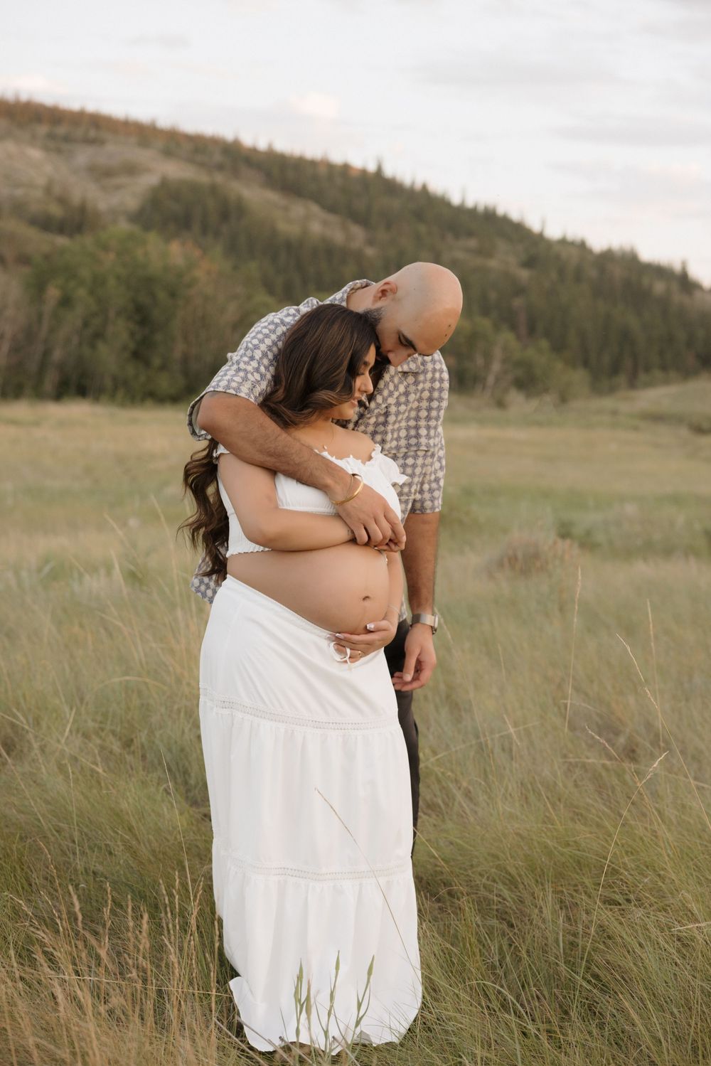 Pregnancy couple embrace each other during photo shoot in calgary alberta