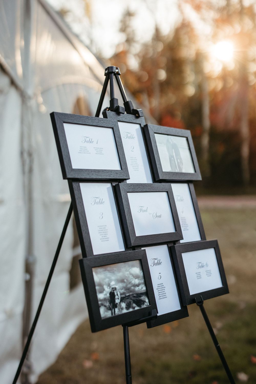 guest seating chart outdoor tent wedding with sun setting behind in Alma New Brunswick wedding photography packages with two photographers