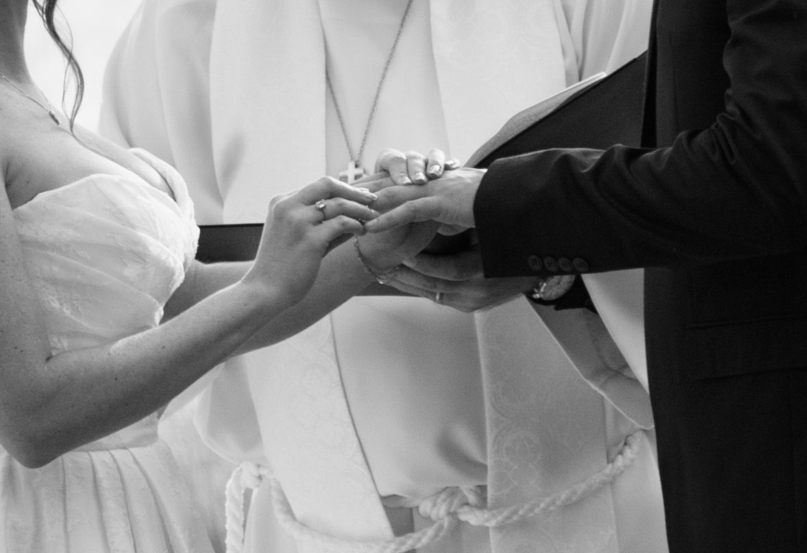 Close-up shots of hands adjusting formal wedding attire buttons and details.
