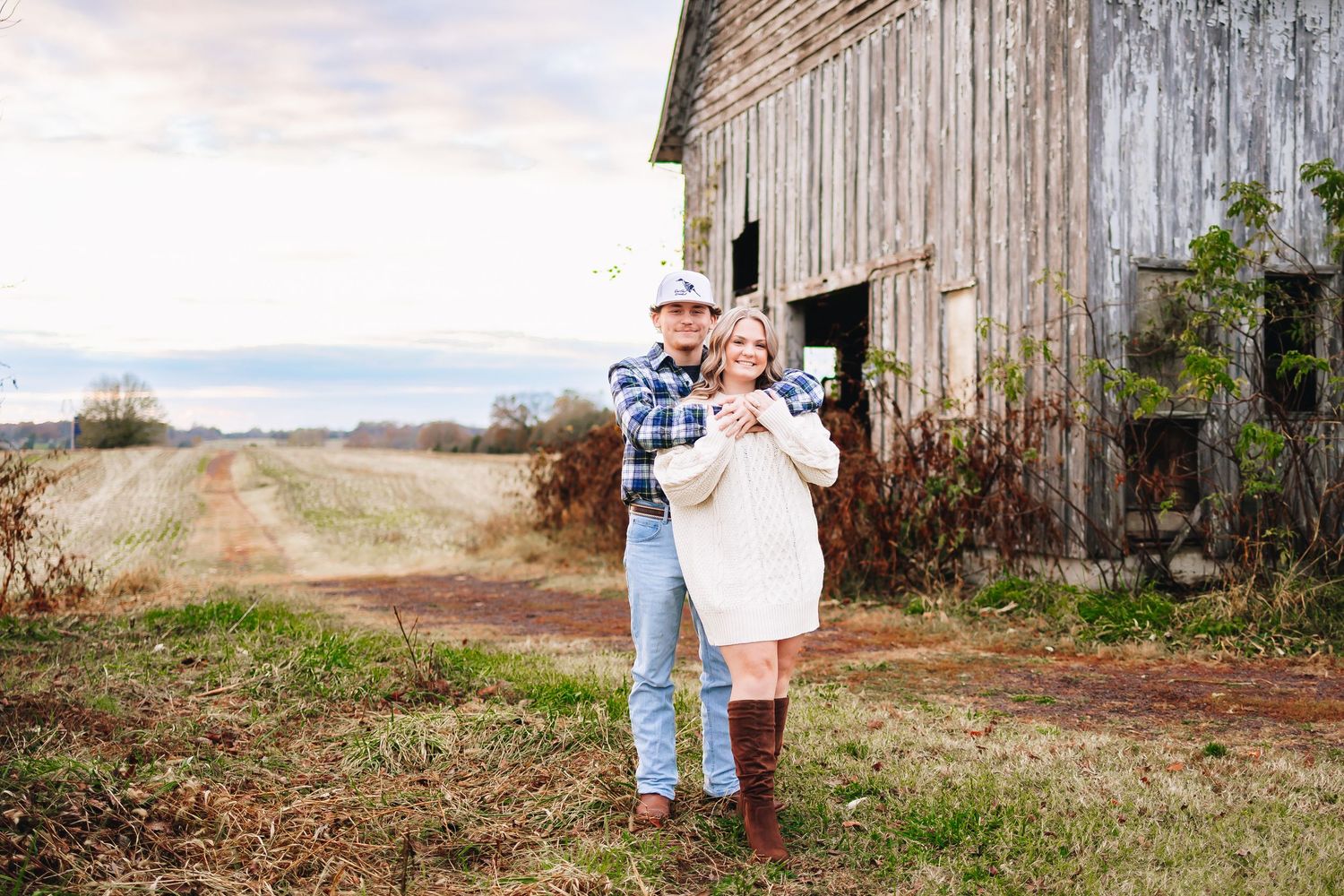 Series of engagement photos captured near a weathered wooden barn in a rural setting.