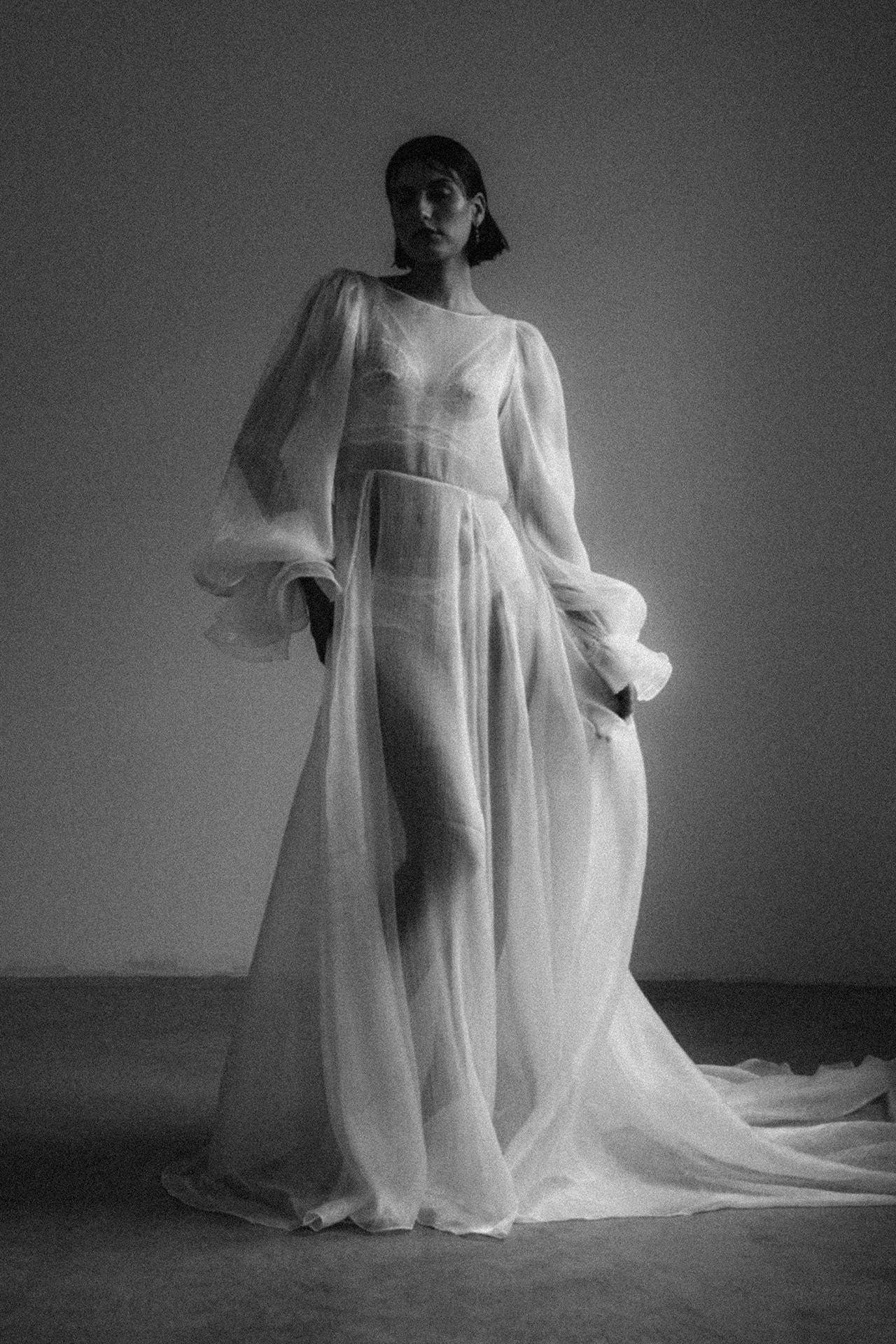 Artistic black and white series showing flowing white sheer fabric in dramatic lighting.
