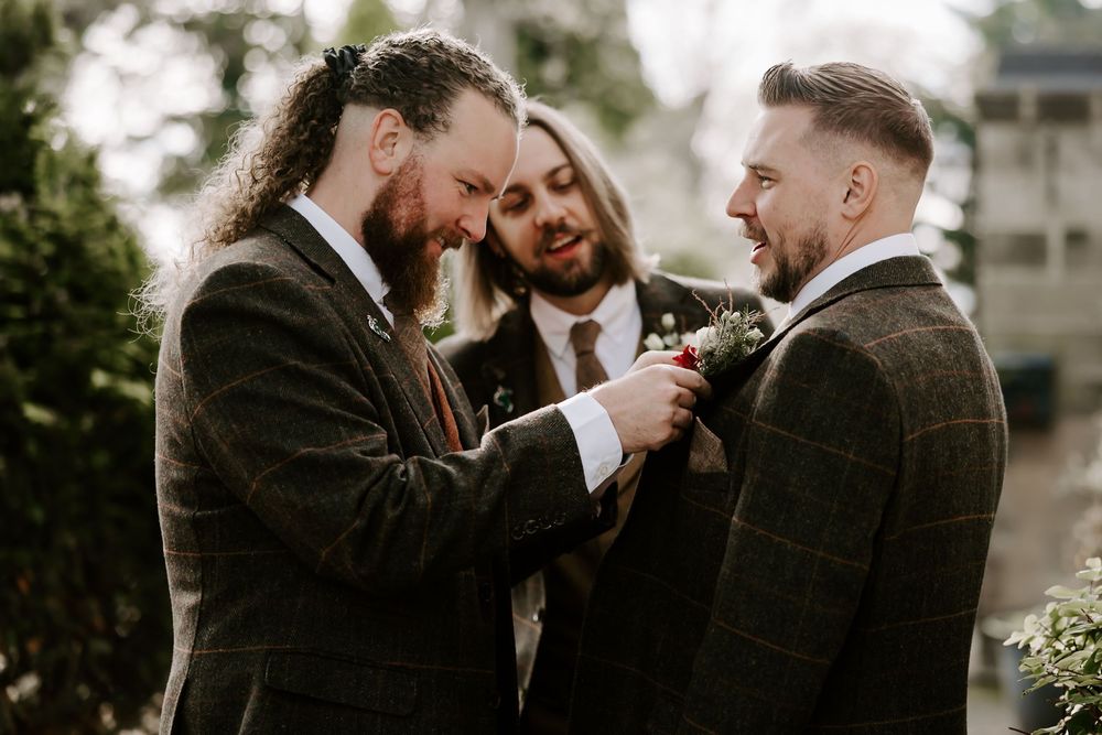 Wedding party shares joyful laughter during an intimate outdoor celebration at dusk.