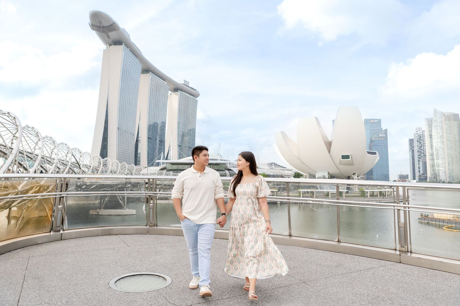 sunrise pre-wedding photos of filipino couple in singapore on the helix bridge with Marina Bay sands & art science museum