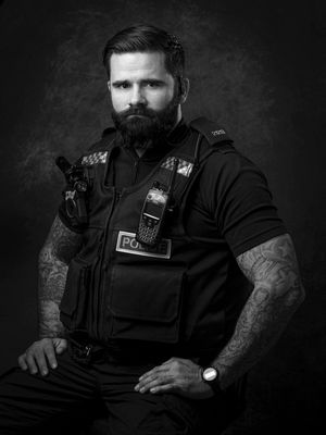 West Mercia Police Officer low key studio portrait.