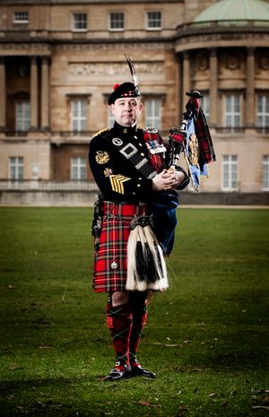 Derek Potter, The Sovereign Piper, in the gardens of Buckingham Palace.
