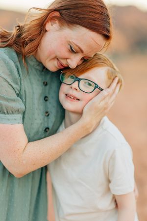Tender moment shared between two people against desert backdrop.