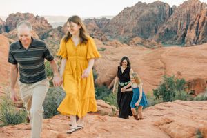 A group walks along scenic red rock trails during a desert adventure.