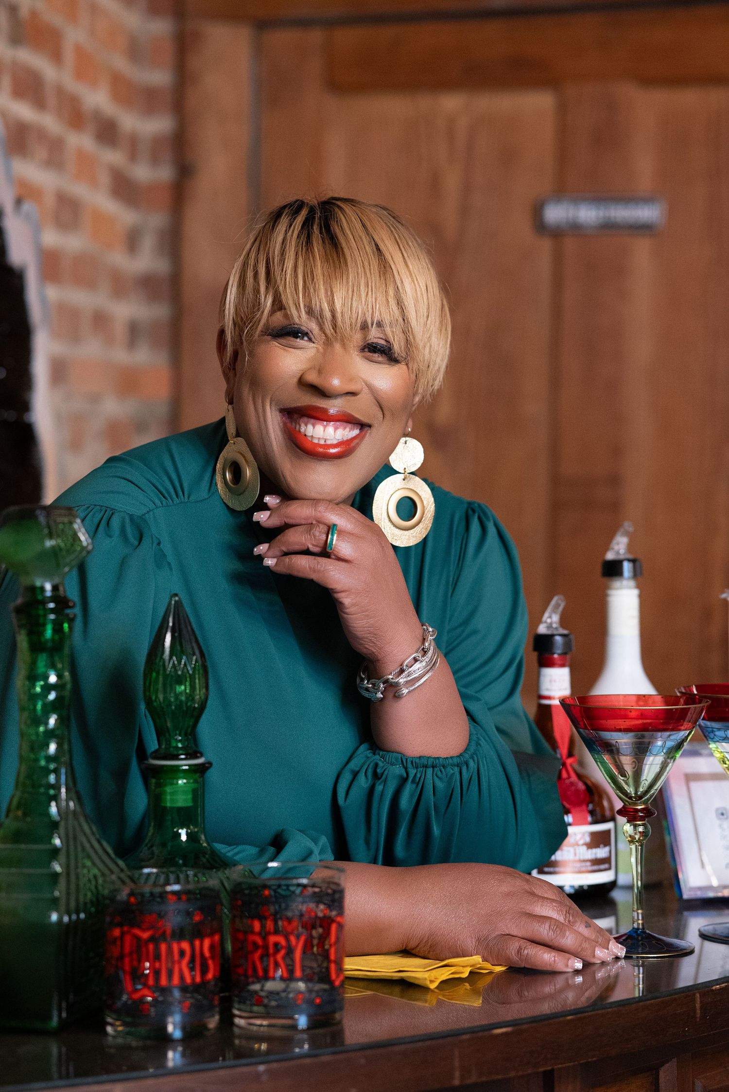 A sequence of four photos showing someone in a green top sitting at a wooden bar with bottles and drinks.