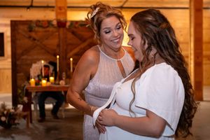 Bride smiling with her mom during their mother–daughter dance at The Barn at Lakeside Ranch wedding reception.