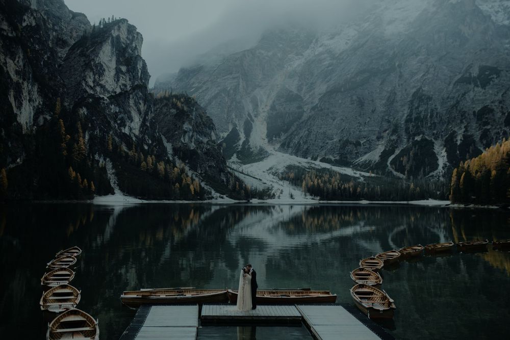 Mountainous lake vista with winding paths and dramatic cloudy atmosphere.