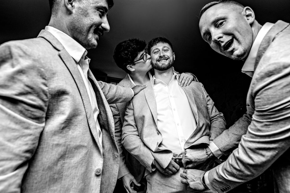 A black and white photo sequence shows joyful dancing and celebration at what appears to be a wedding reception.