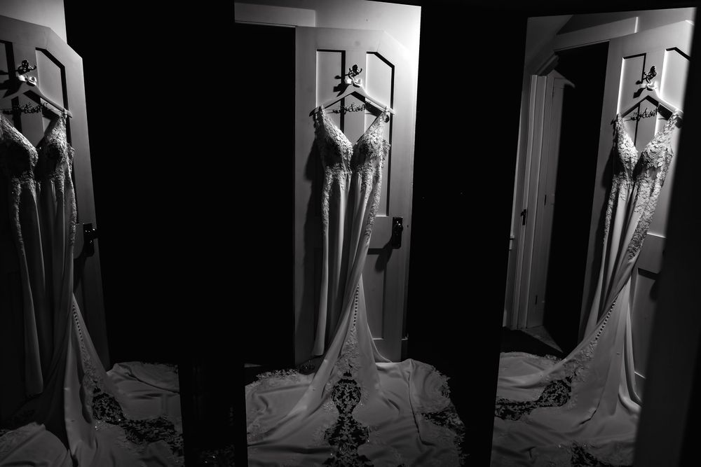 A black and white photo series showing a figure in an elegant dress posing dramatically against a dark background.