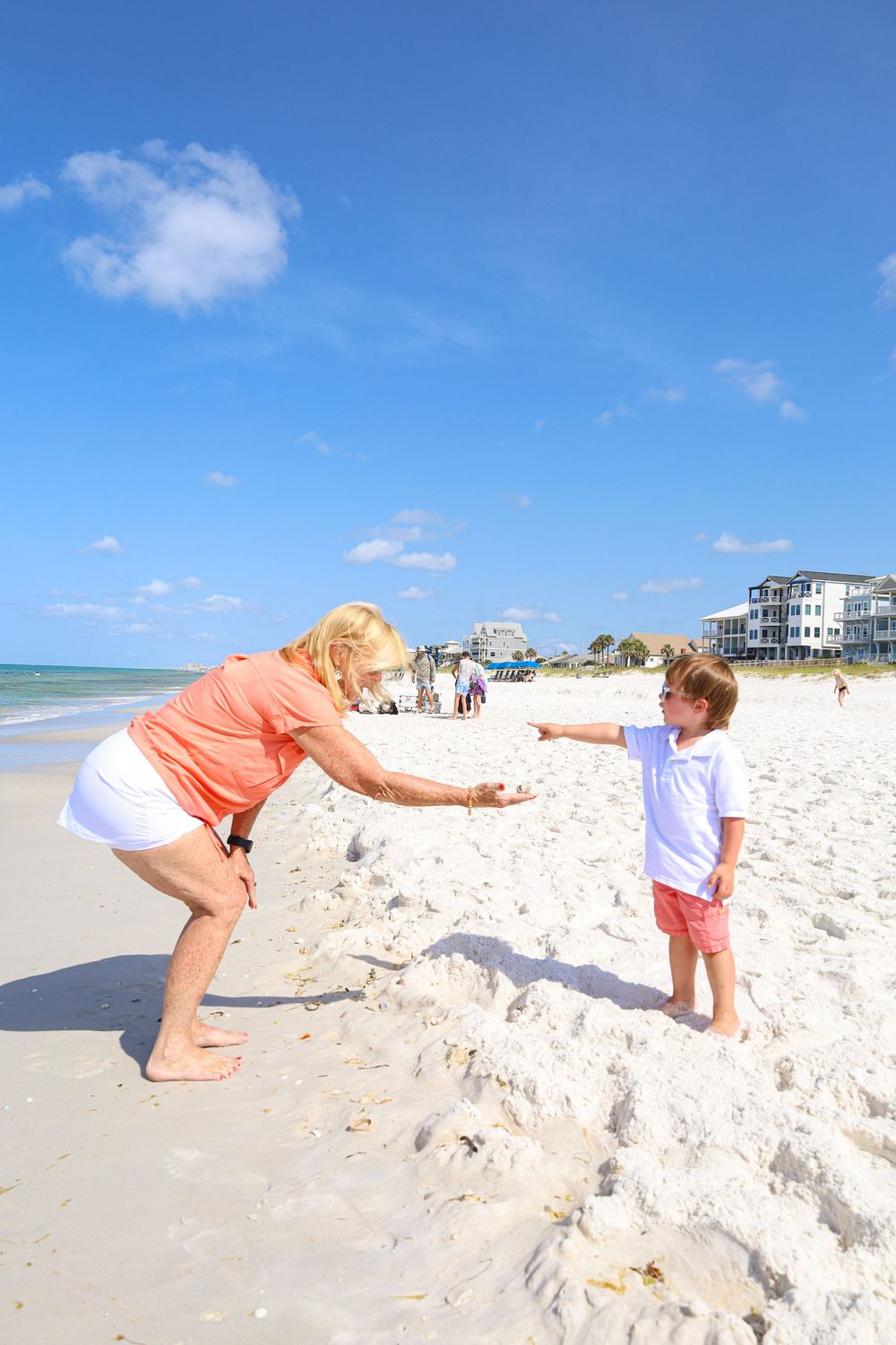 A sequence of photos showing someone digging in white sand on a sunny beach with blue skies and ocean in the background.