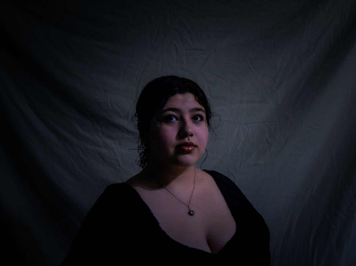 A dramatic black and white portrait series showing different angles and poses against a dark background.