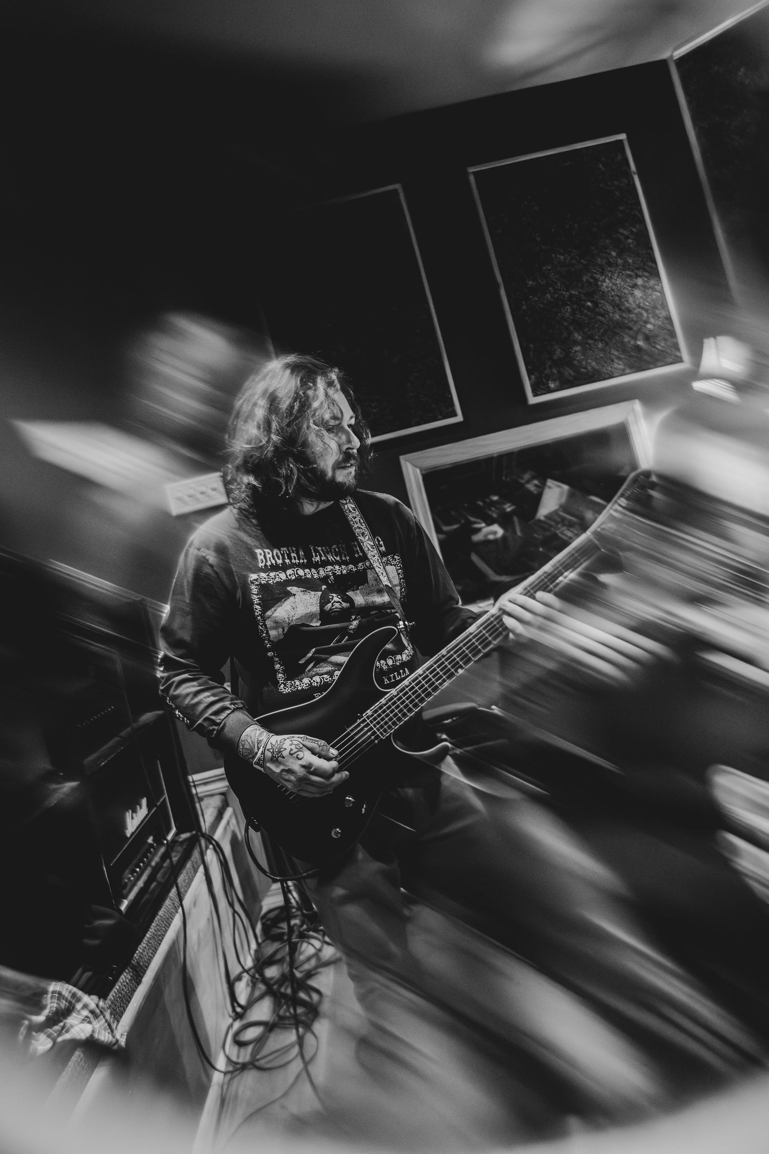 Black and white photo of guitarist playing electric guitar.