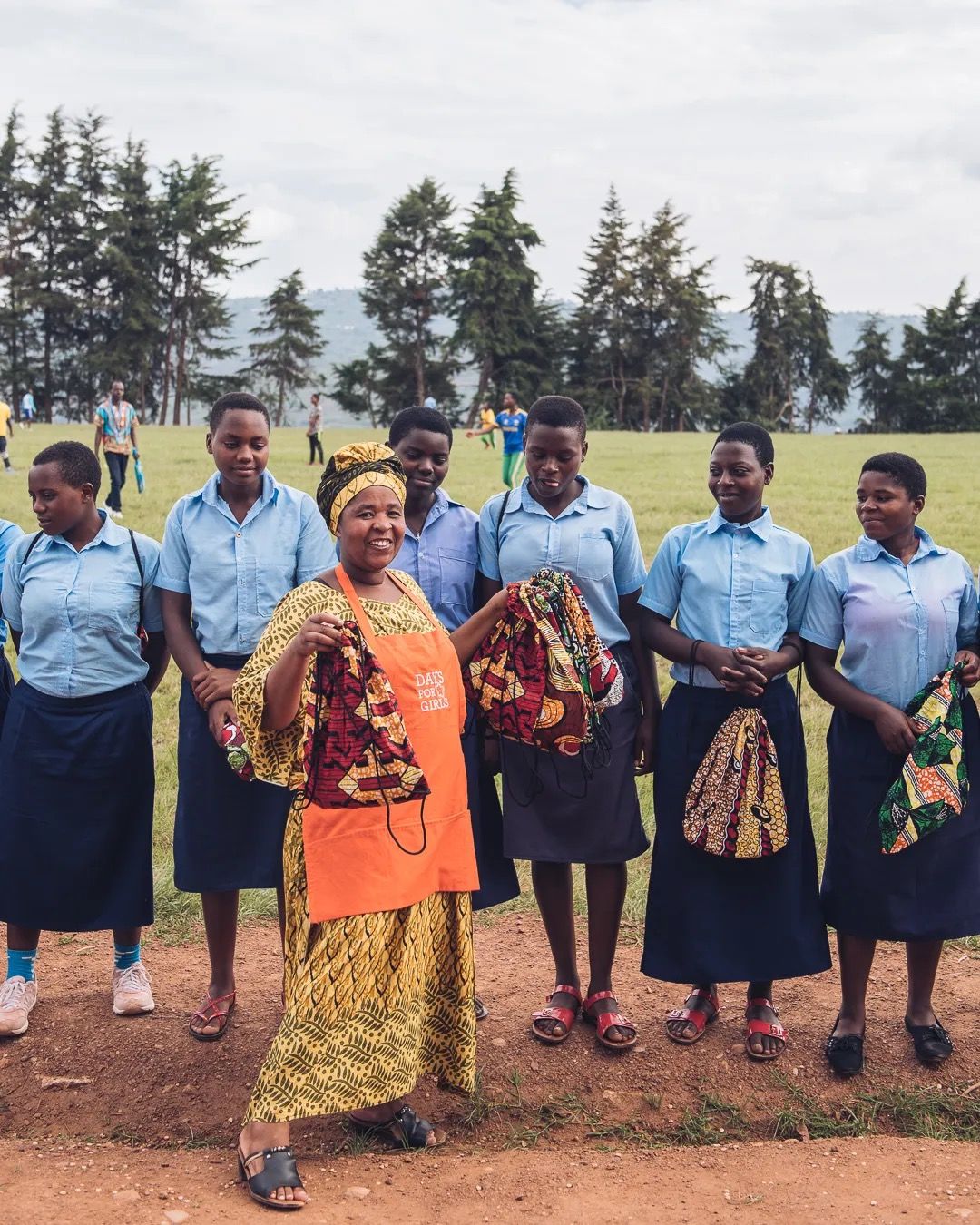 A group of community members standing outdoors during a local education and support initiative.