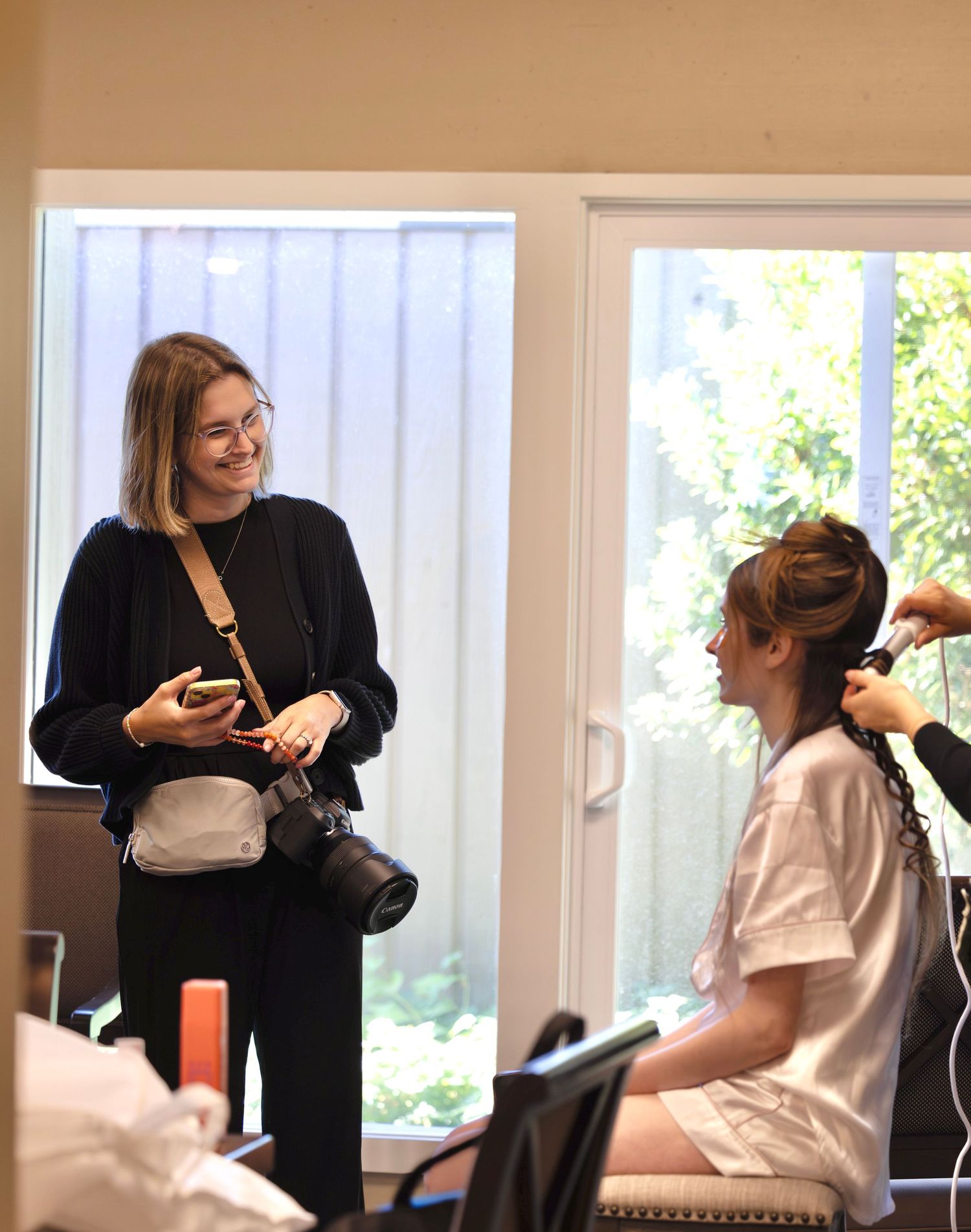Behind the scenes of photographer working with client in indoor studio setting.