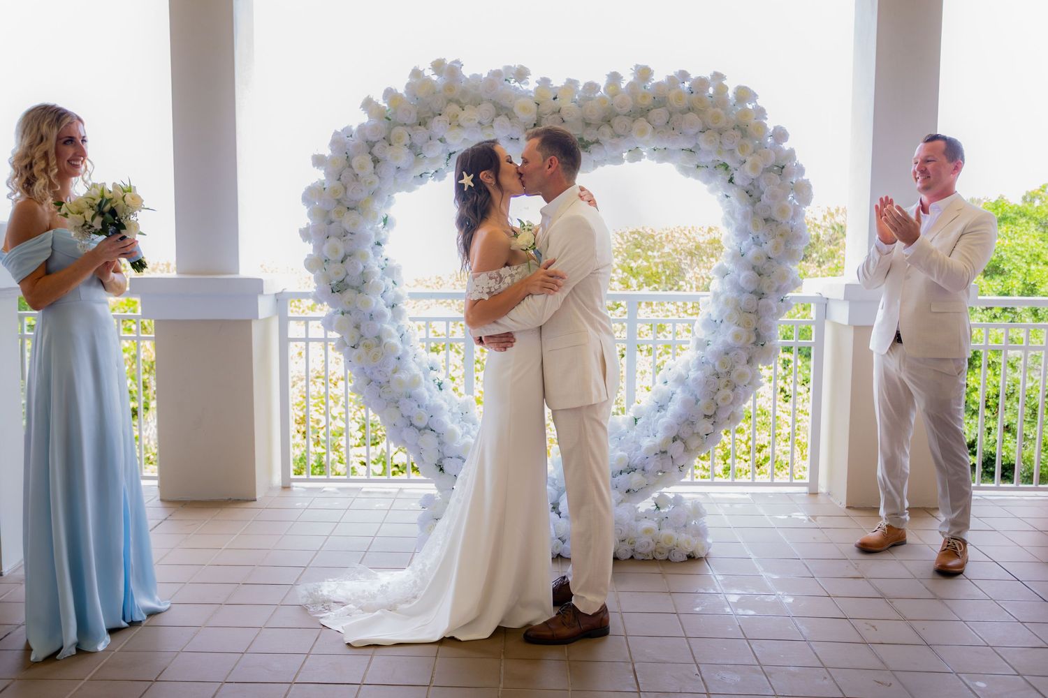 Bride and grooms first kiss on balcony at palm beach shores community center