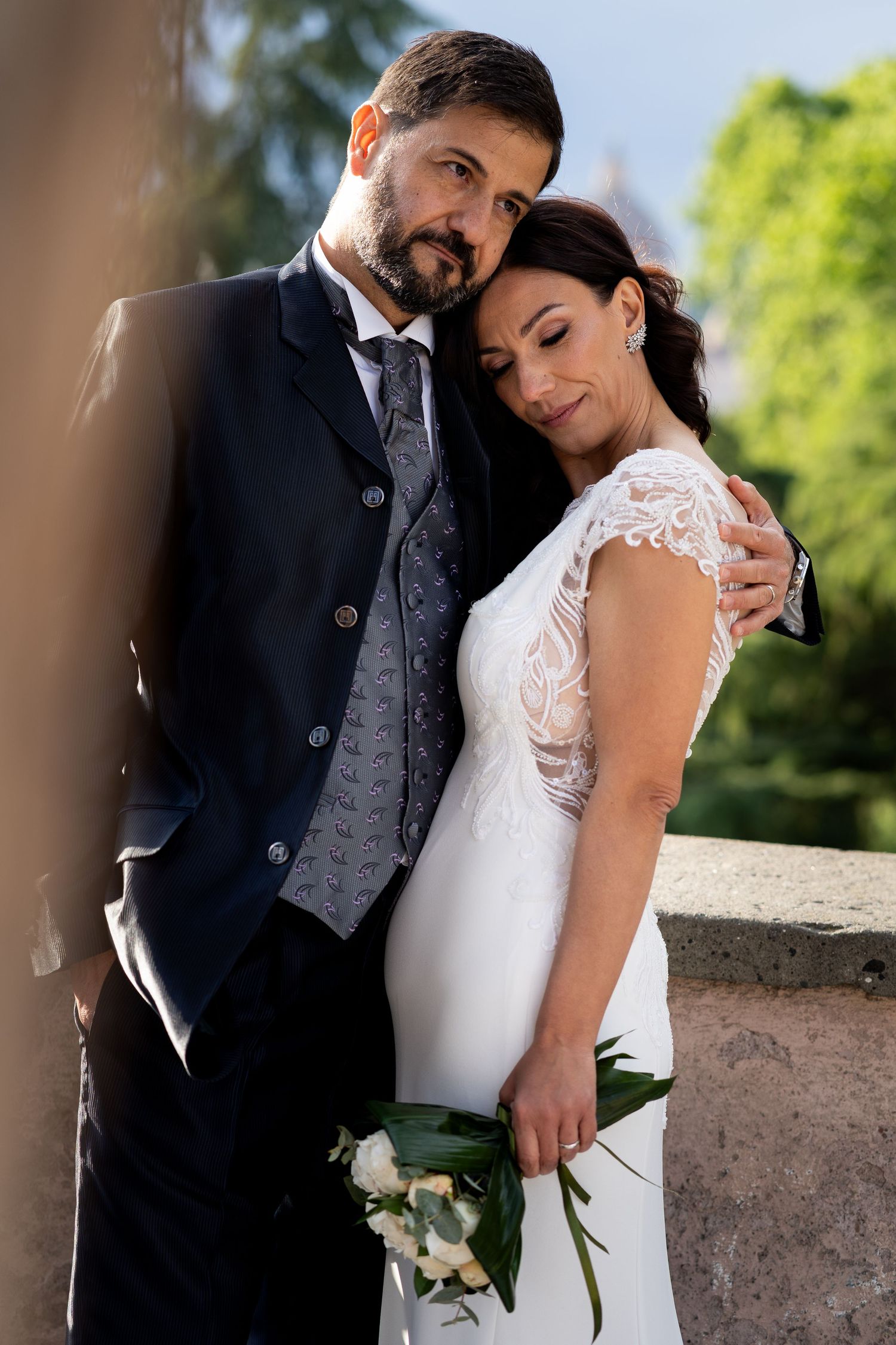 Newlywed couple shares intimate romantic moments in outdoor garden setting across series of wedding photos showing their love.