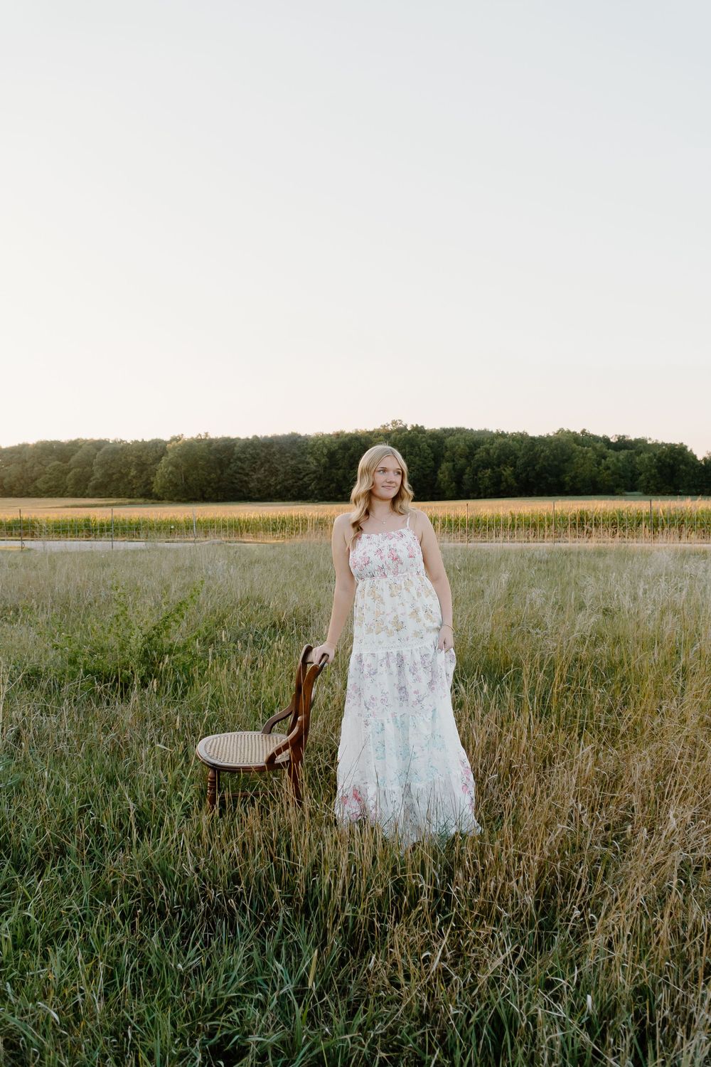 A series of outdoor portraits in a rustic field setting with tall grass and natural lighting at golden hour.