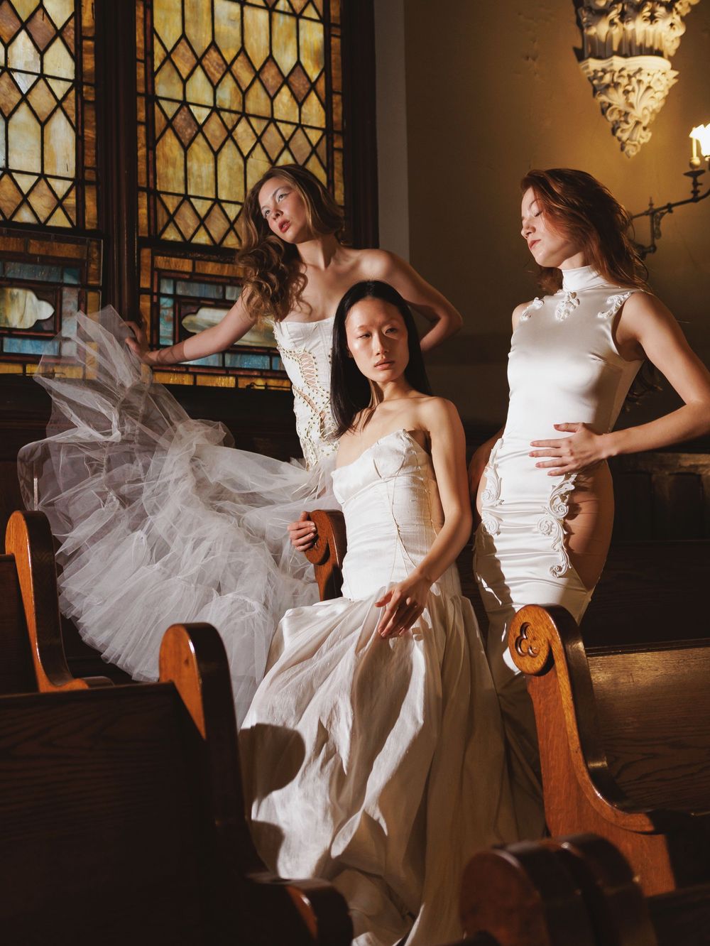 Dynamic dance poses captured in sequence against a dark church interior with dramatic lighting.