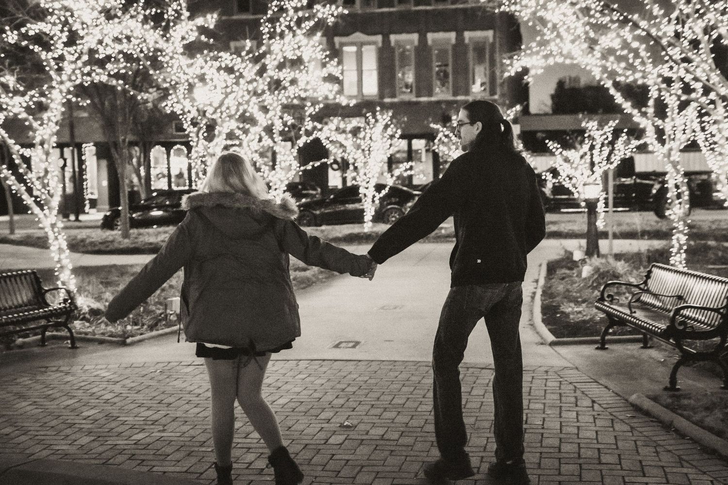 Couple walking downtown bowling green, Kentucky during candid Christmas mini session