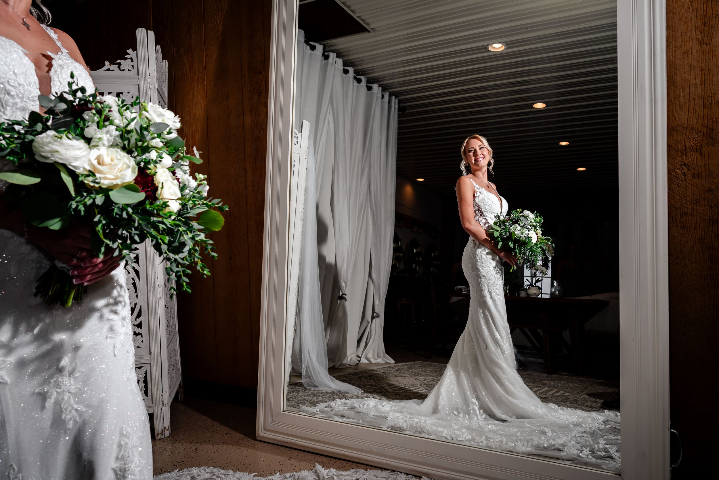 Wedding party members pose in a dimly lit indoor venue with elegant decor.
