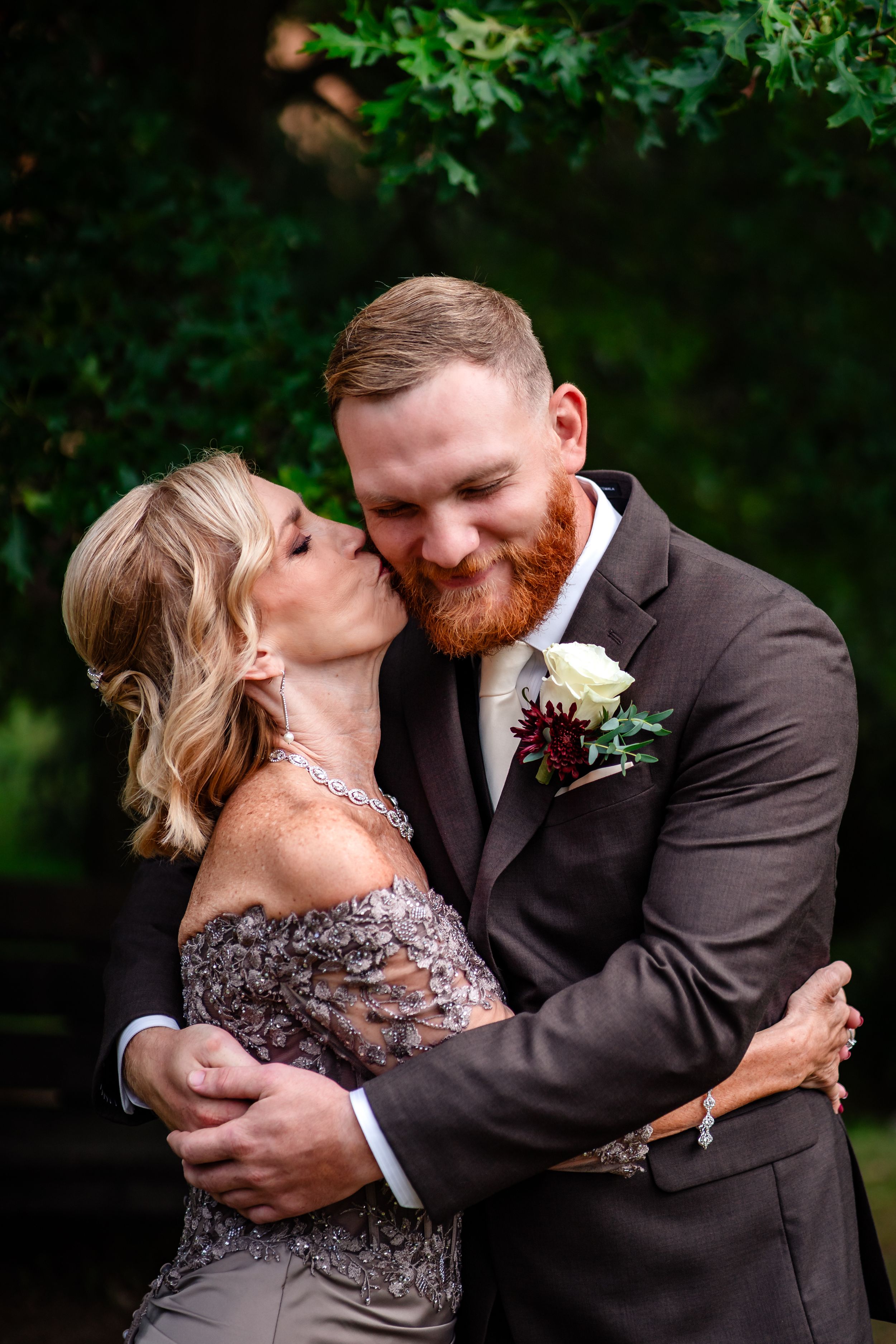 Romantic wedding portraits taken in a garden setting with lush green foliage.